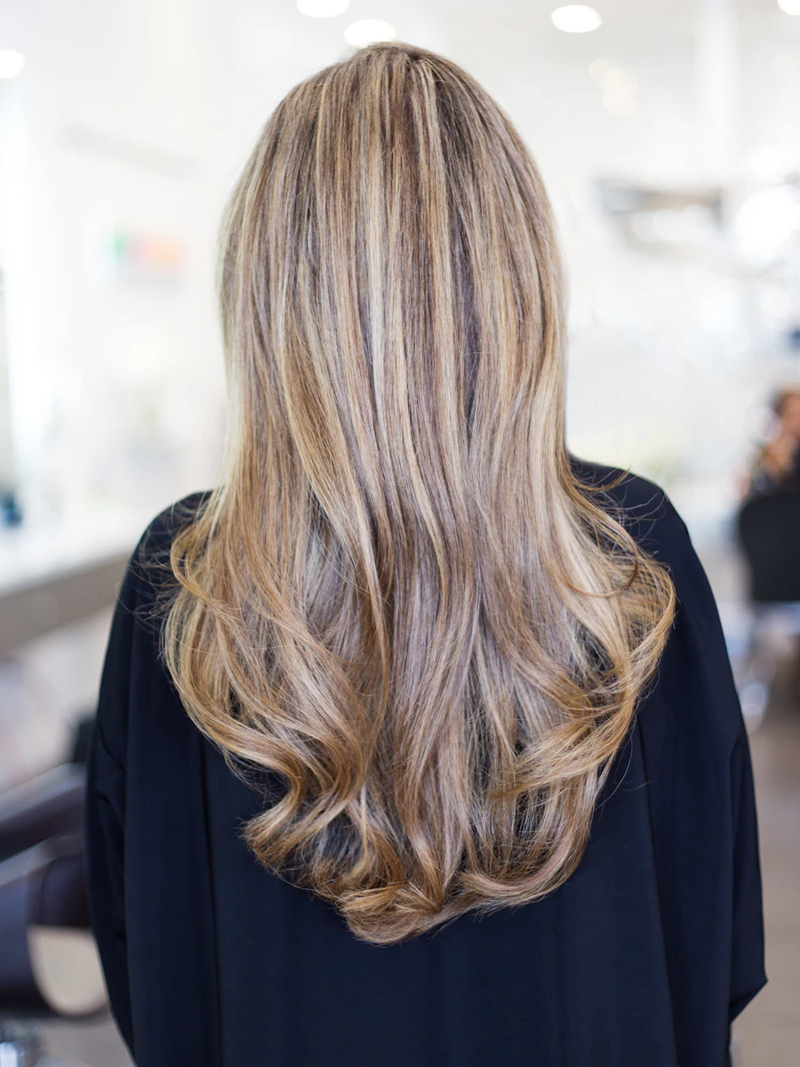 Melena larga con balayage rubio miel, vista de espaldas